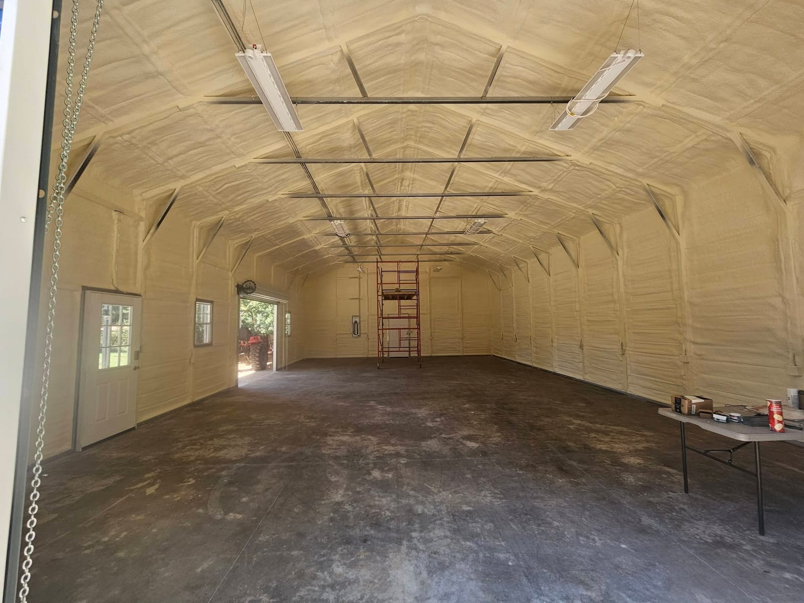 Finished metal shop interior insulated with spray foam on the walls and ceiling