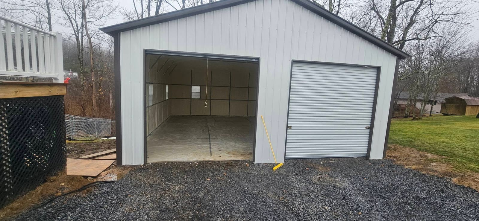 Metal garage with spray foam insulation visible through the open door