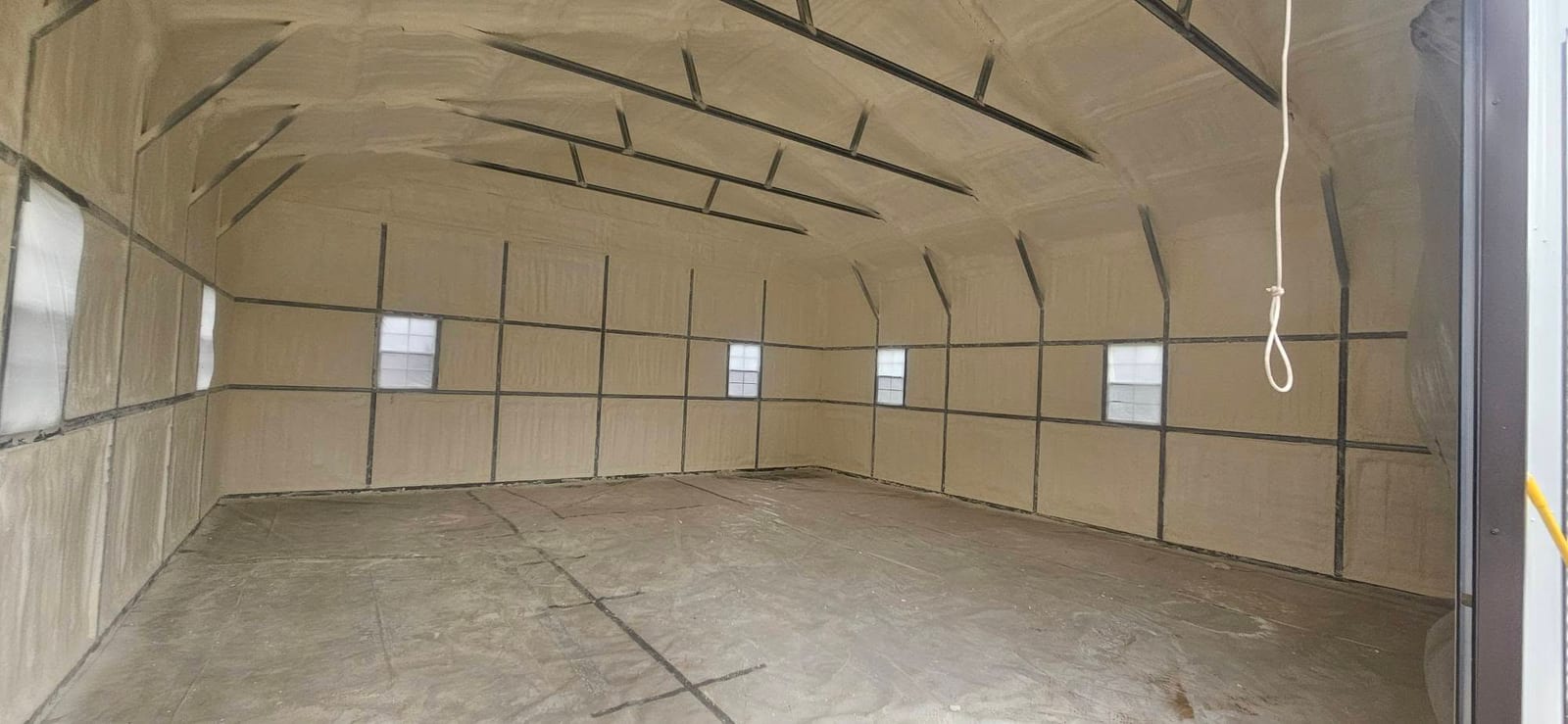 Garage interior with spray foam insulated walls around the windows